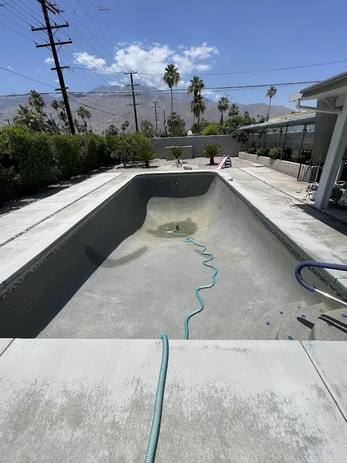 Pool drained and being cleaned before refill