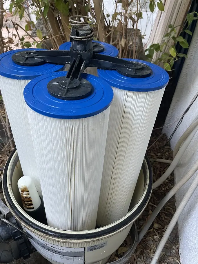 Clean pool filter cartridges being reinstalled in a filter housing