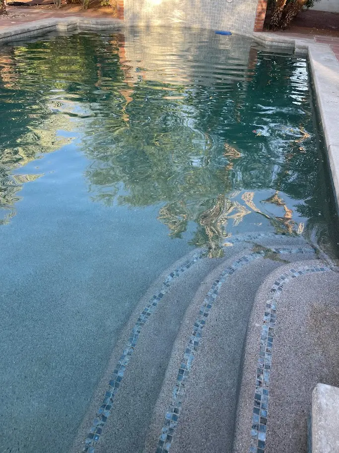 Clean pool steps with mosaic tile at sunset