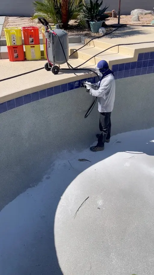 Rivera Pool technician cleaning a drained pool in the Coachella Valley